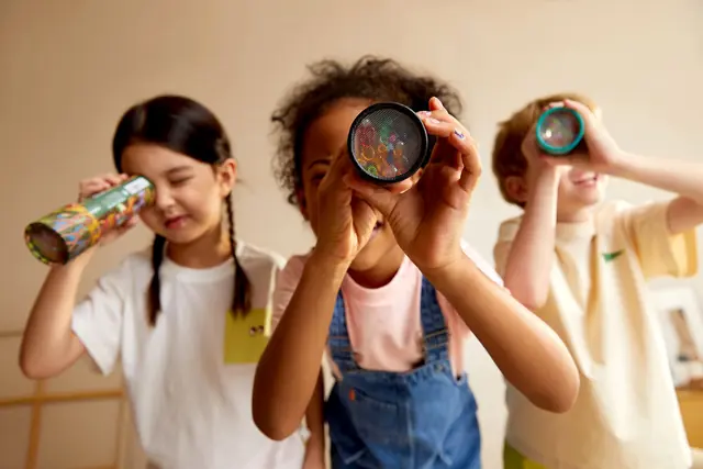 Children looking through mideer telescopes