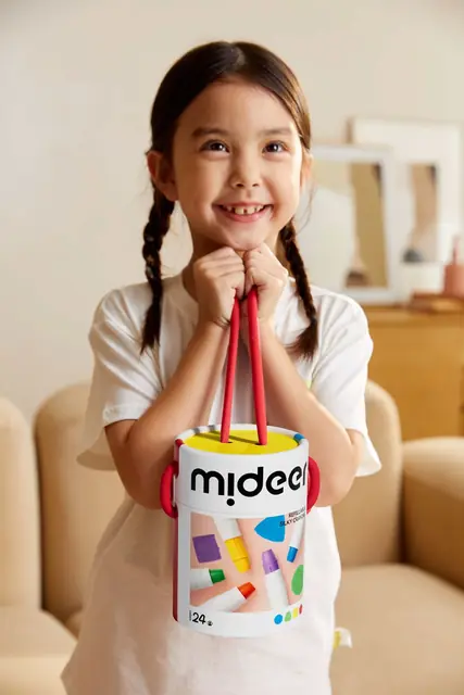 A girl holding a mideer art bucket