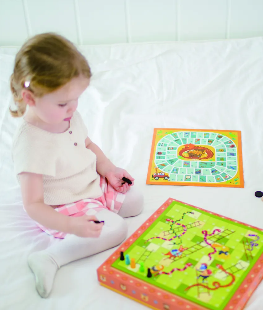 A young girl playing a mideer board game
